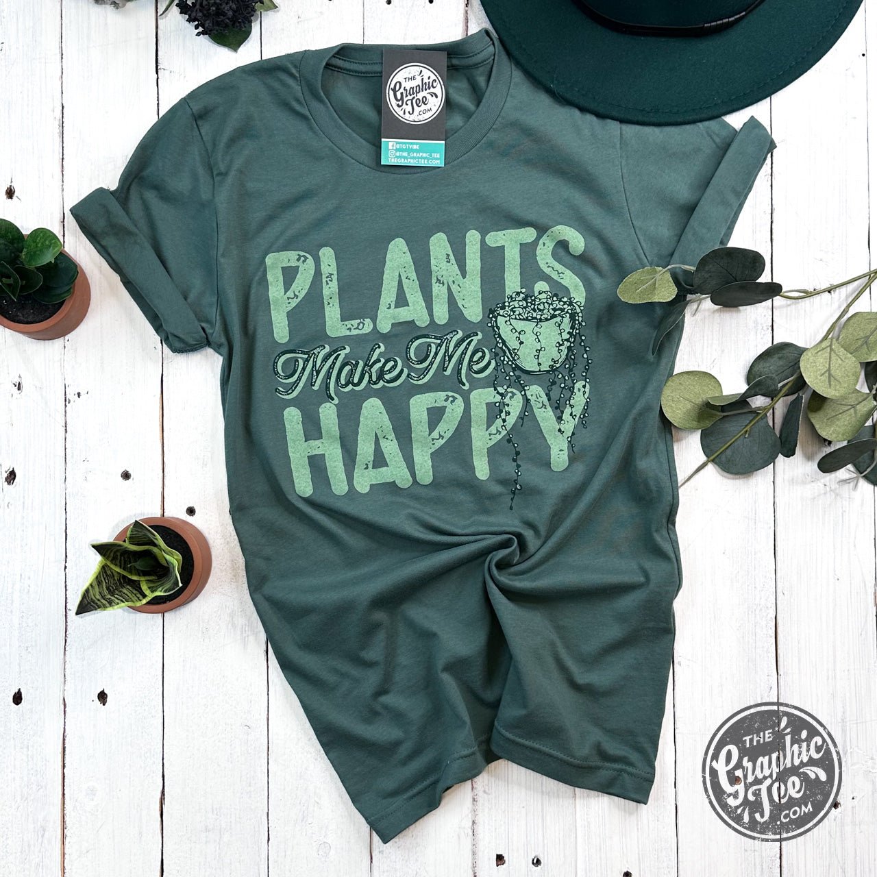 The Graphic Tee Plants Make Me Happy short sleeve graphic T-shirt with a colorful plant design on white fabric.