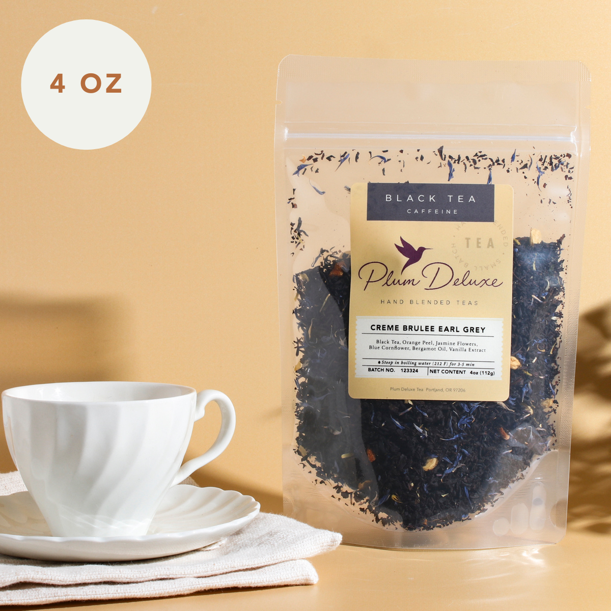 Plum Deluxe Earl Grey Black Tea with Creme Brulee flavor in an 8-ounce package, showing the tea leaves and packaging.