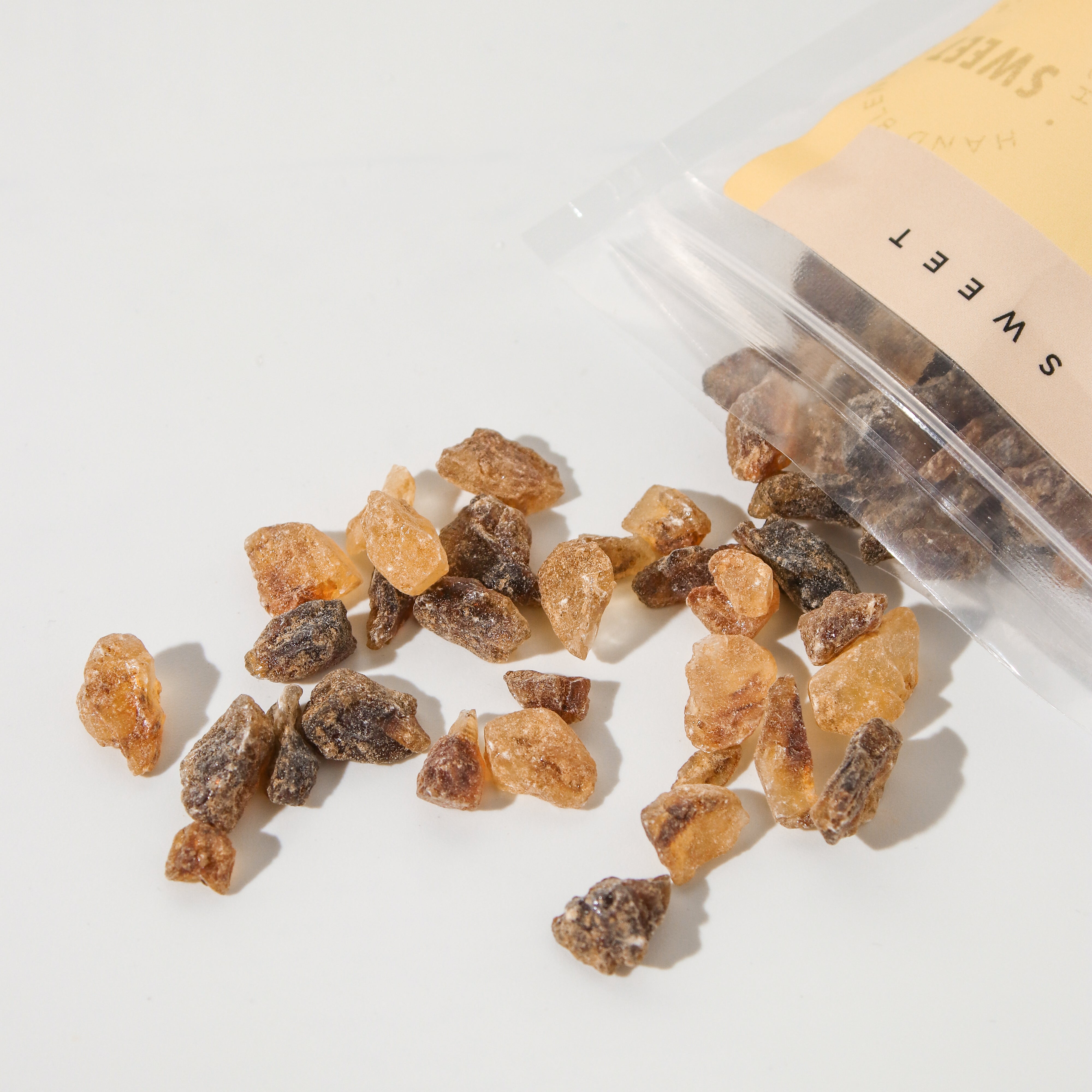 Plum Deluxe Tea Deluxe Tea Sugar rock sugar for tea in a clear jar, showing large crystalline sugar pieces for sweetening tea.