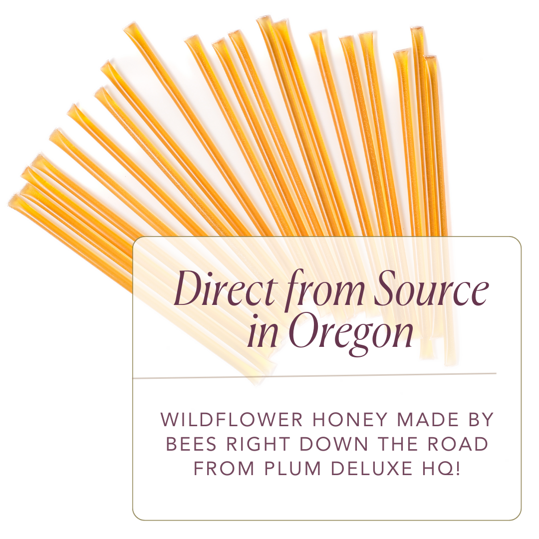 Amber carrot blossom honey sticks from Plum Deluxe Tea, ideal for sweetening tea with natural honey.