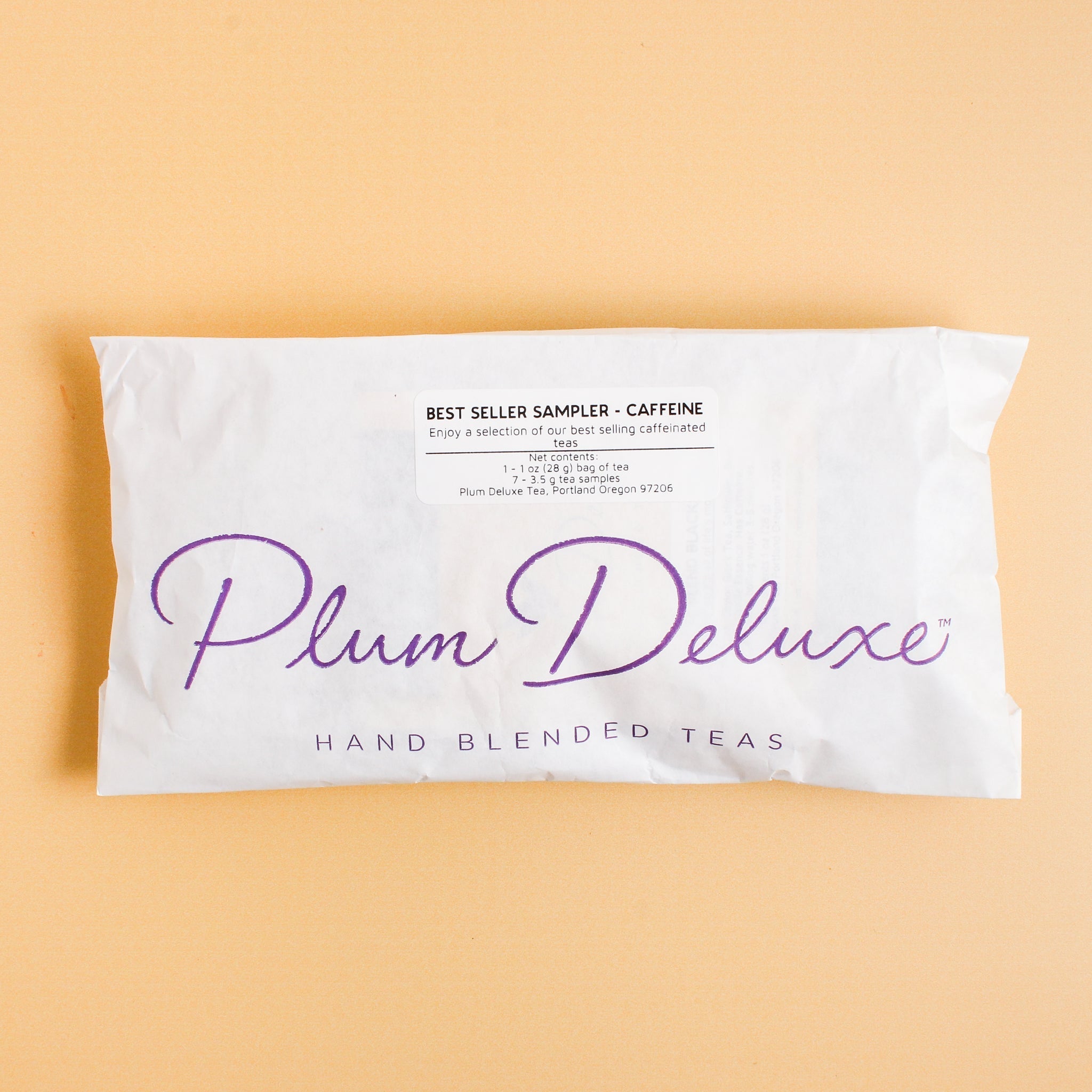 Assorted Plum Deluxe Tea Best Sellers Sampler Set featuring various caffeinated tea blends in colorful packaging.