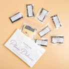 Assorted Plum Deluxe Tea best sellers sampler set featuring various caffeinated tea blends in colorful packaging.