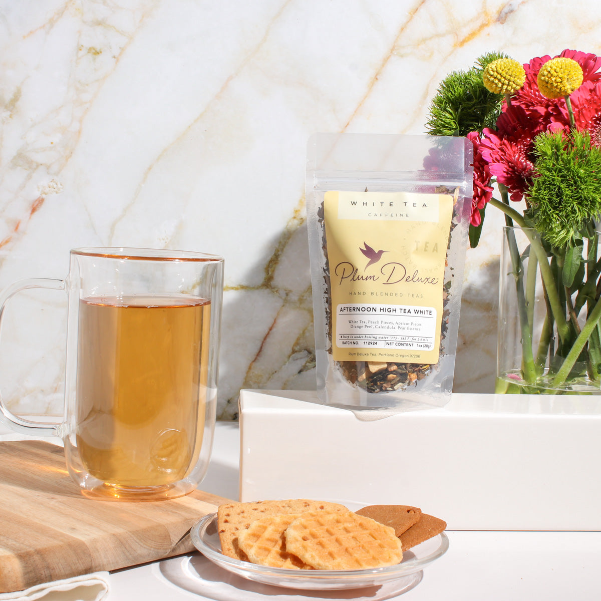 White tea blend with peach and pear flavors from Plum Deluxe Tea, featuring a delicate, fragrant tea leaves and fruit pieces.