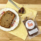 Cup of Plum Deluxe Banana Bread Herbal Dessert Tea with chocolate and chestnut flavors in a clear glass mug.