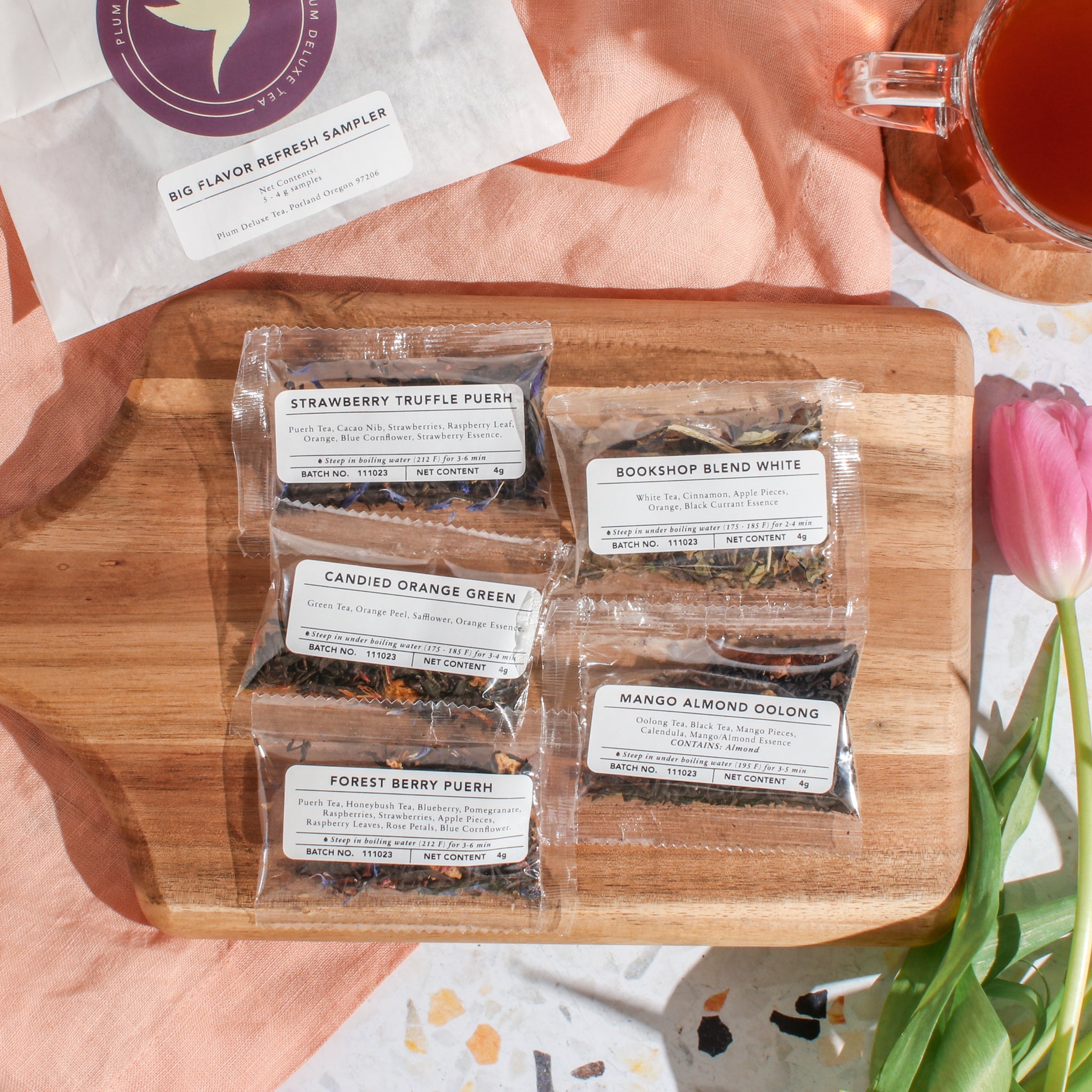 Assorted tea sampler kit from Plum Deluxe Tea featuring a variety of flavors in a colorful box.