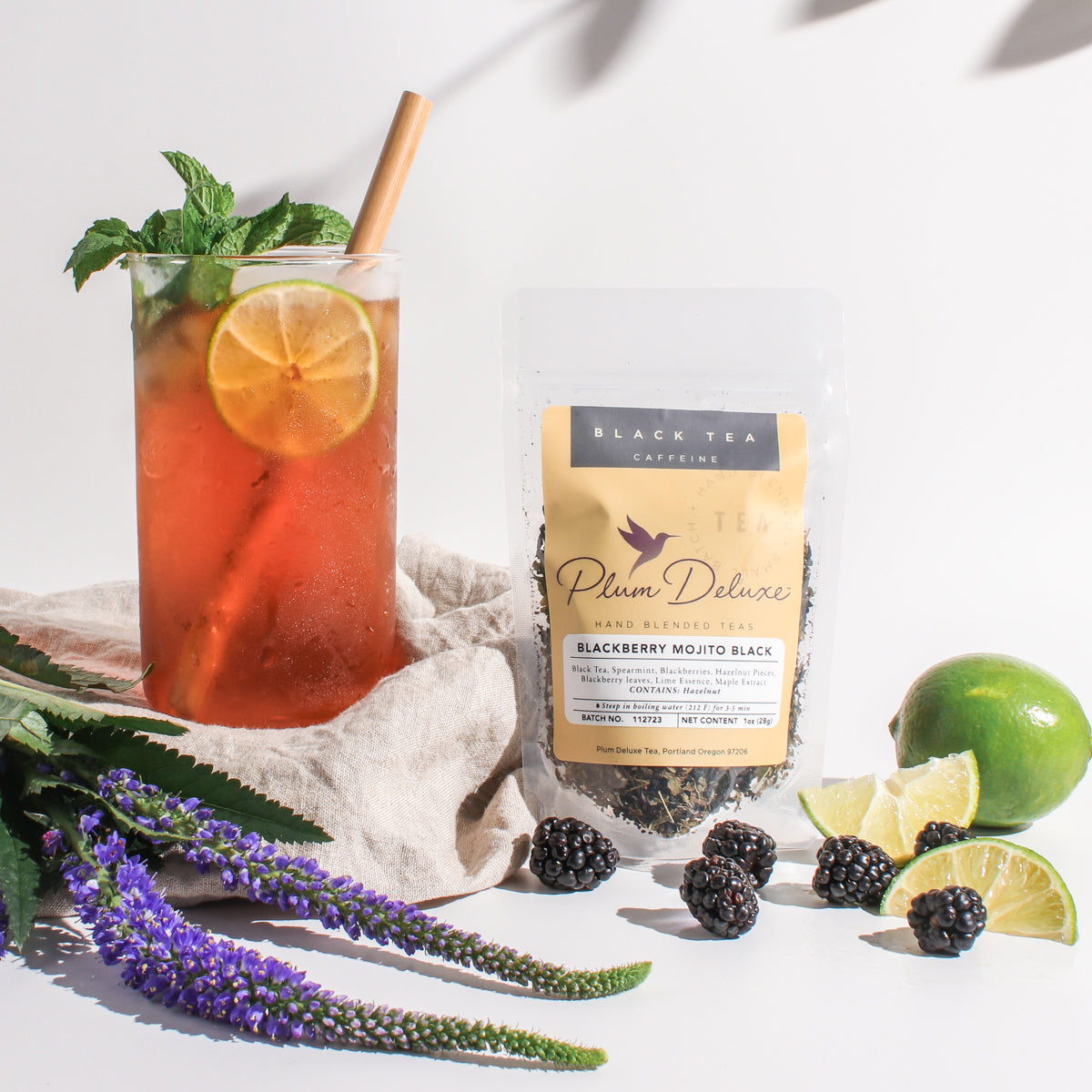 Blackberry Mojito Black Tea by Plum Deluxe, showing fresh blackberries, lime, maple, and spearmint in a brewed tea cup.