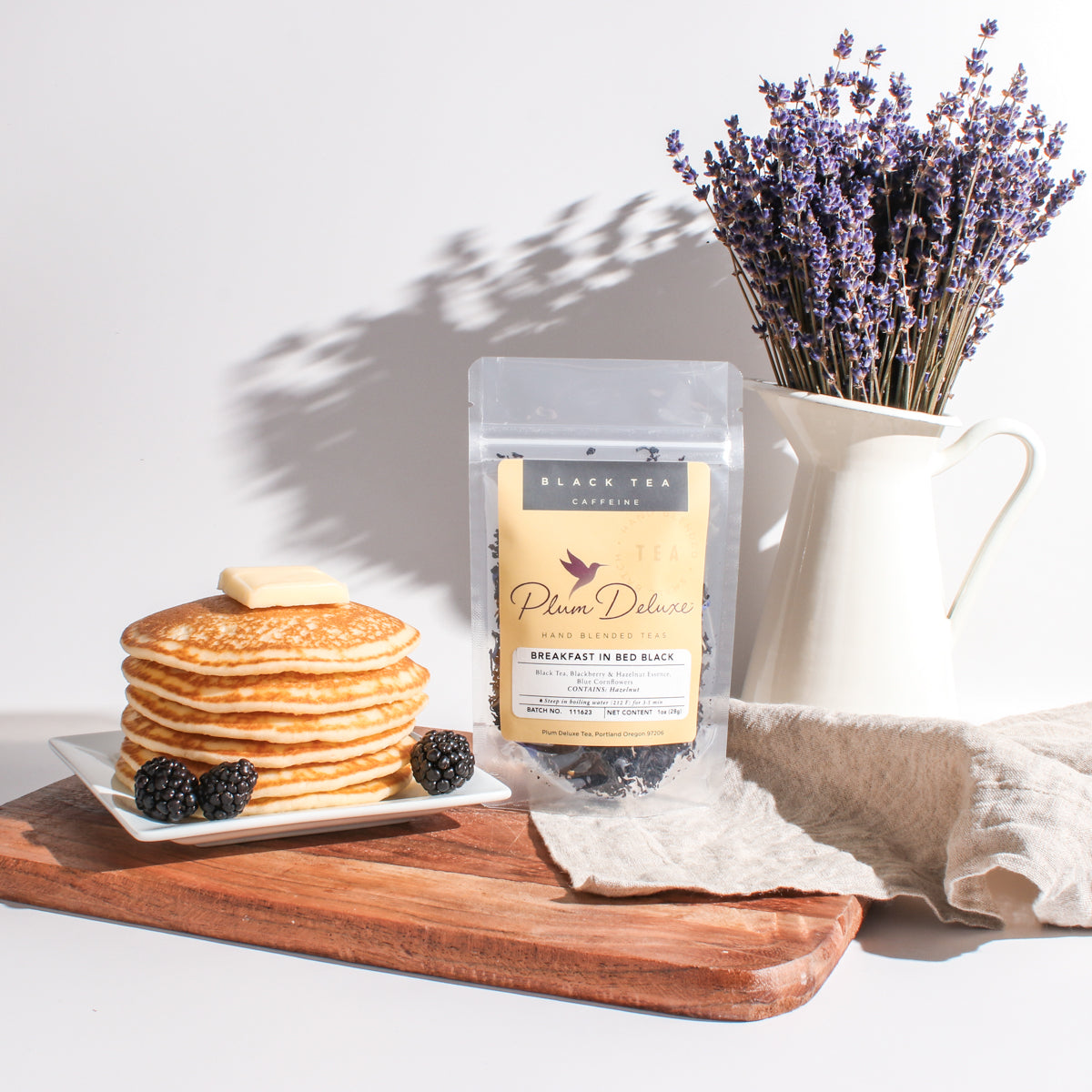 Breakfast in Bed Black Tea by Plum Deluxe, featuring blackberry and hazelnut flavor in a brewed black tea cup.