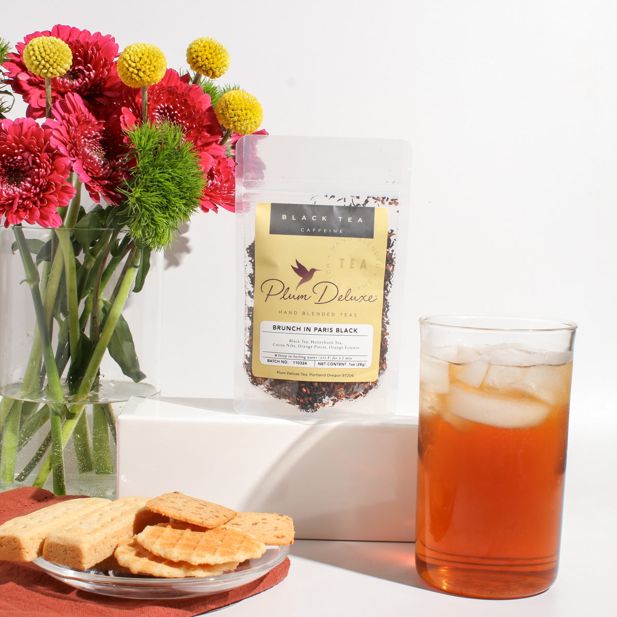 Plum Deluxe Tea Brunch in Paris black tea blend with chocolate and orange, showcasing the loose tea leaves in a clear container.