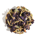 Dry butterfly pea flowers from Plum Deluxe Tea in a clear glass jar, showcasing vibrant blue petals for herbal tea.