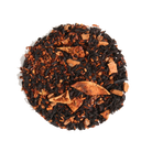 Brewed cup of Caramel Almond Black Tea by Plum Deluxe Tea with tea leaves, caramel pieces, and almonds in a clear glass mug.