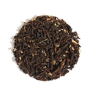 Jar of Caramel Brittle Puerh tea from Plum Deluxe Tea with caramel-colored tea leaves and a clear glass container.