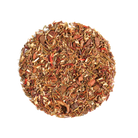 Glass cup of caramel snickerdoodle herbal dessert tea by Plum Deluxe Tea with cinnamon and caramel swirls.
