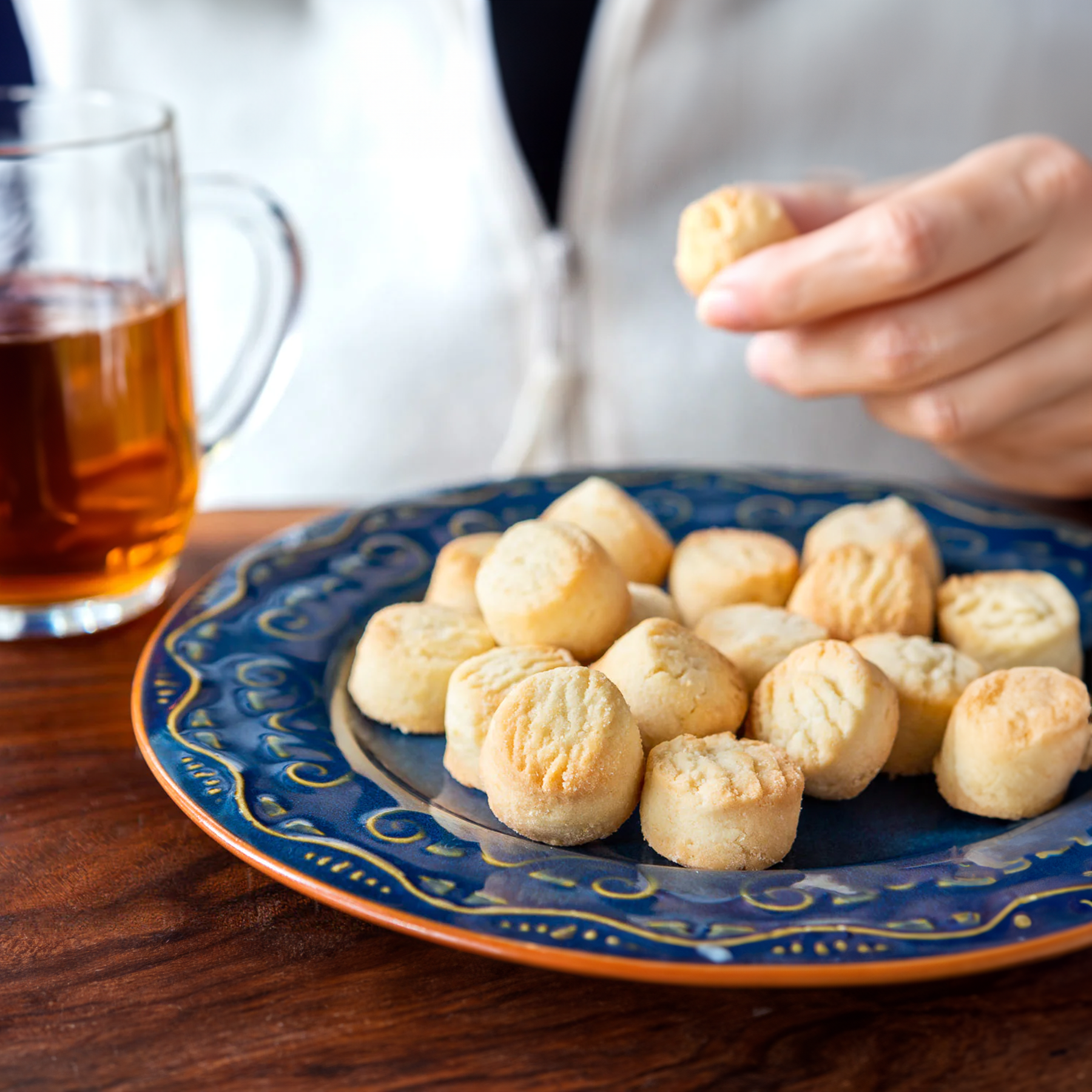 Plum Deluxe Tea Classic Shortbread Bites in a decorative box with golden accents and a close-up of the buttery, crumbly cookies.