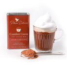Dairy-free Comfort Cocoa Hot Cocoa Mix by Plum Deluxe Tea, showing the hot cocoa mix in a cozy mug with cocoa powder.