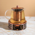 Copper Rose glass teapot with warmer by Plum Deluxe Tea, showcasing a elegant teapot and cozy warmer for brewing tea.