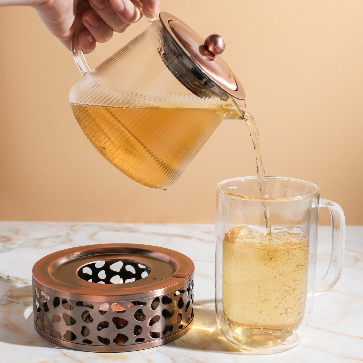 Copper Rose Glass Teapot with Warmer by Plum Deluxe Tea, clear glass teapot showcasing a copper rose design and matching warmer