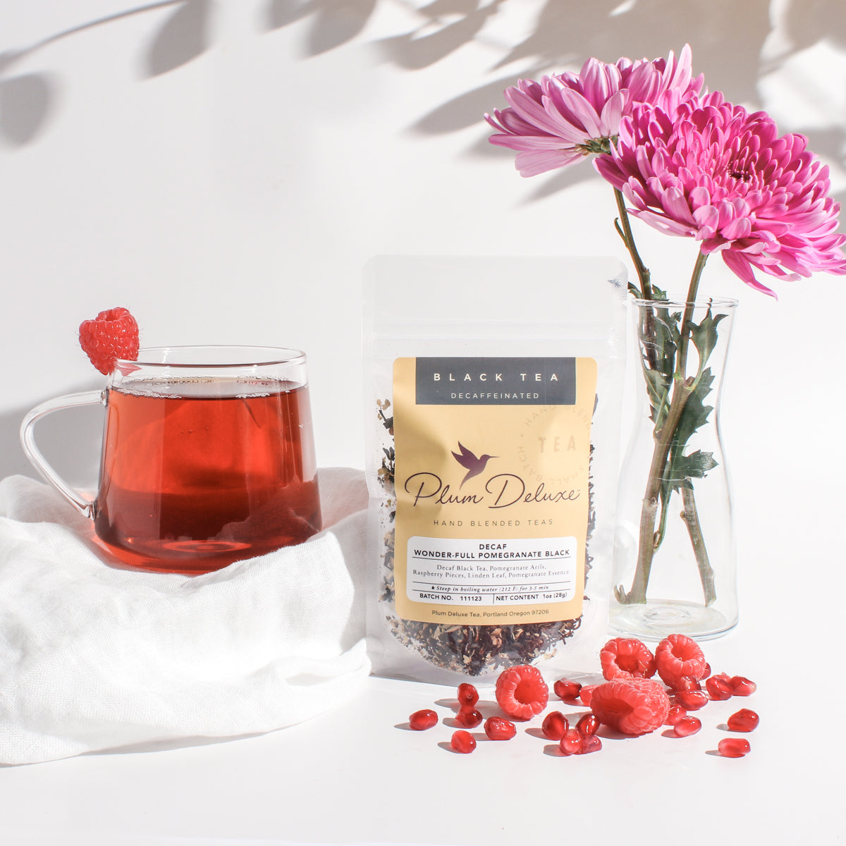 Decaf Wonder-Full Pomegranate Black Tea by Plum Deluxe Tea, showing a steaming cup of rich black tea infused with pomegranate.