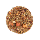 Herbal tea from Plum Deluxe featuring vibrant dragonfruit flavor in a clear glass cup with fresh fruit pieces.