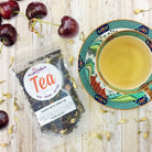 Garden Grove Green Tea by Plum Deluxe with jasmine and cherry flavors in a tea bag or loose leaf display.