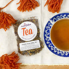 Golden Cacao Herbal Tea by Plum Deluxe featuring turmeric and chocolate in a vibrant tea blend.