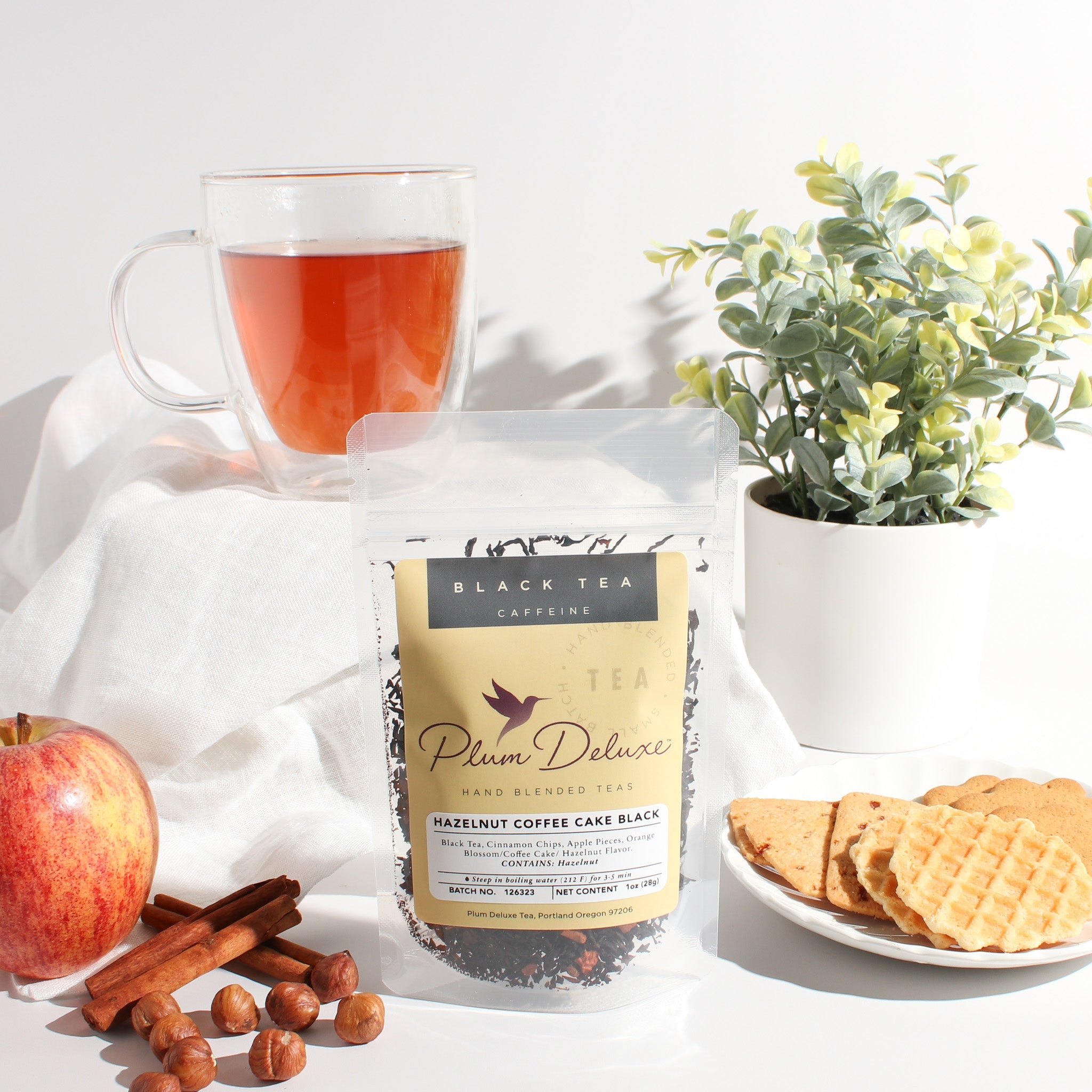 Hazelnut Coffee Cake Black Tea by Plum Deluxe featuring hazelnut, apple, and cinnamon flavors in a tea cup.