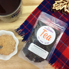 Heritage Blend Black Tea by Plum Deluxe, featuring Maple Scottish Breakfast flavor, in a teapot with loose tea leaves.