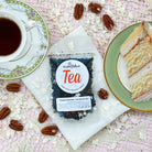 Italian Wedding Cake Blend Dessert Tea by Plum Deluxe featuring caramel, coconut, and pecan flavors in a packaged tea bag.