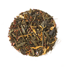 Cup of Plum Deluxe Mango-Apricot Green Tea in a white mug, showcasing the vibrant tea with fruit pieces inside.