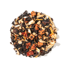 Cup of Plum Deluxe Maple Ginger Butterscotch Black Tea in a white mug showing rich amber color and tea leaves on a wooden table