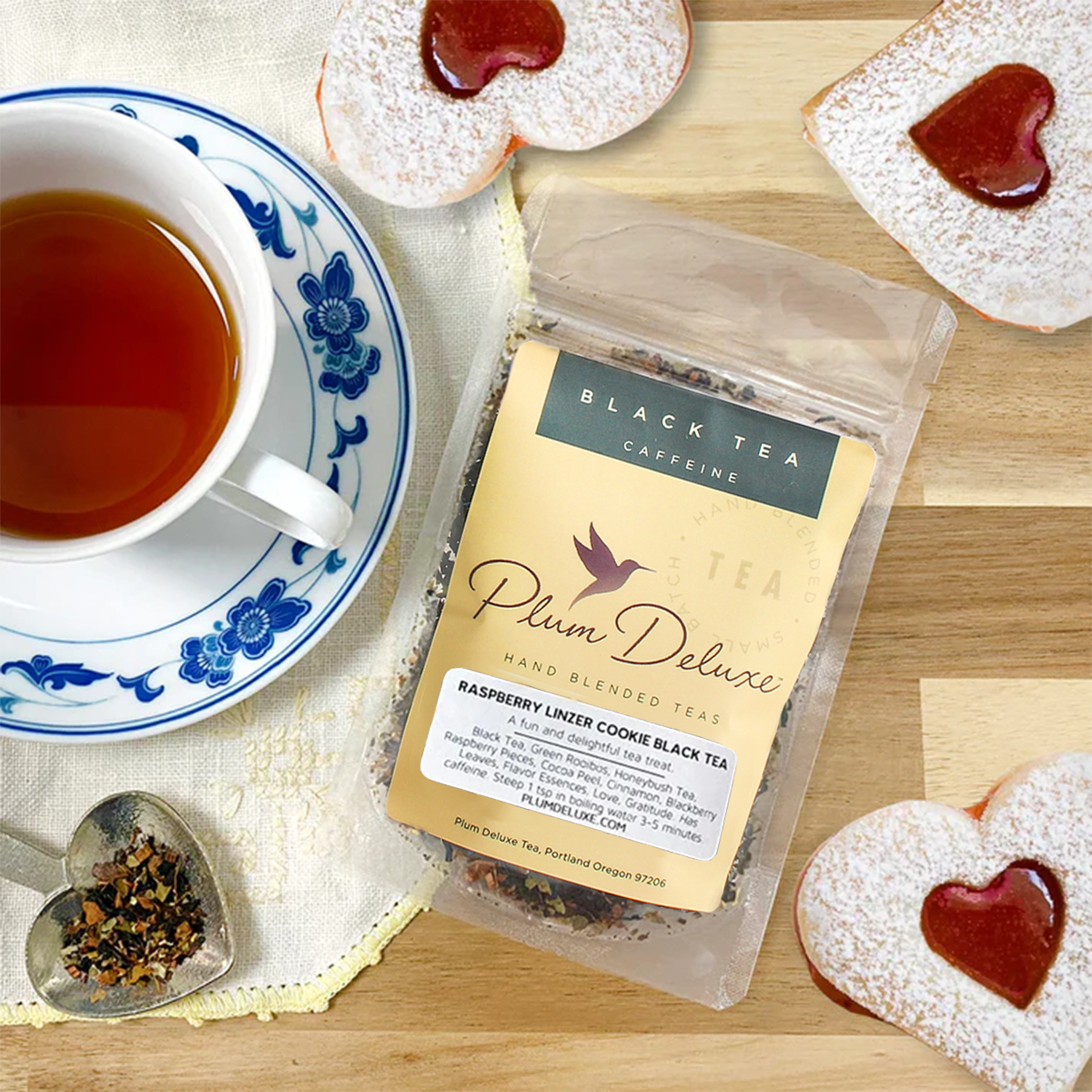 Raspberry Linzer Cookie Dessert Tea by Plum Deluxe Tea, featuring a steaming cup with raspberry and cookie flavors.