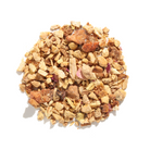 Herbal tea cup with Rejuvenation Blend by Plum Deluxe Tea, featuring ginger and lemon flavors in a natural setting.