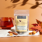 Plum Deluxe Salted Caramel Black Tea in a clear tea jar, showcasing the rich caramel-infused black tea leaves.