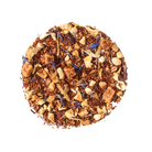 Plum Deluxe Soul Warmer Herbal Tea with hazelnut, chestnut, and caramel flavor in a glass teacup.