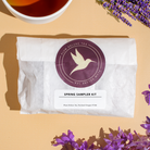 Assorted tea sample kit with 11 flavors from Plum Deluxe Tea Spring Collection, featuring colorful tea bags and packaging.