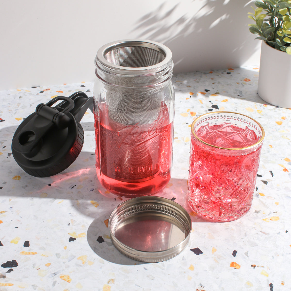 Plum Deluxe Tea Ultimate Iced Tea Bundle with tea, pitcher, and lemonade for refreshing cold beverage preparation.