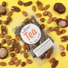 Plum Deluxe Toasted Nut Brulee Oolong Tea in a glass teacup showing its rich amber color and aromatic steam.