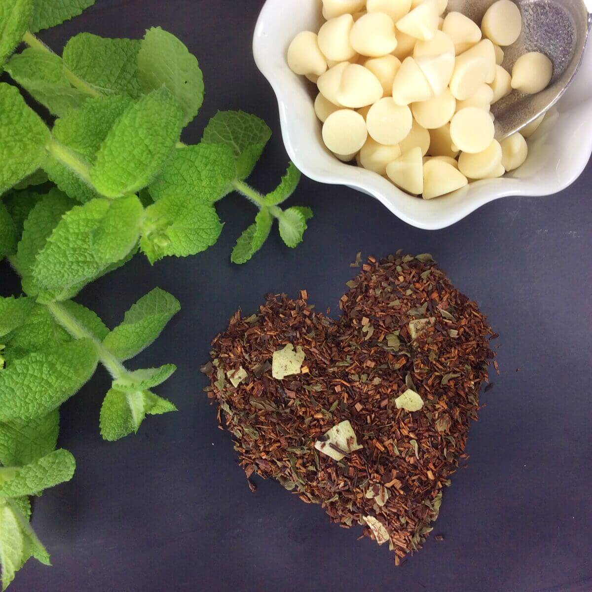 White Chocolate Peppermint Herbal Tea by Plum Deluxe Tea, featuring a steaming cup with white chocolate and peppermint flavors.