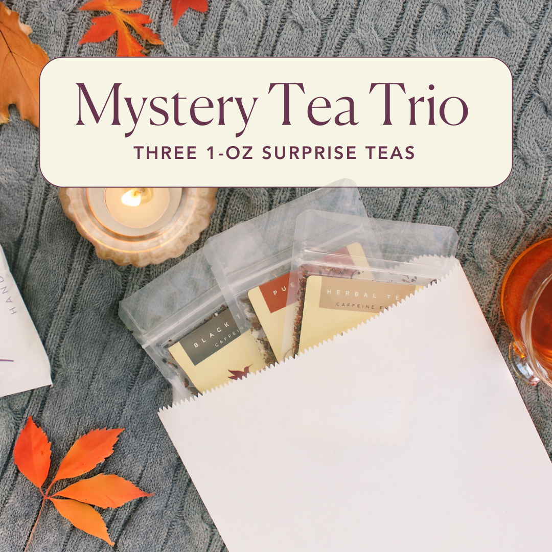 Assorted herbal mystery tea trio from Plum Deluxe Tea with three different colorful tea blends in clear glass cups.