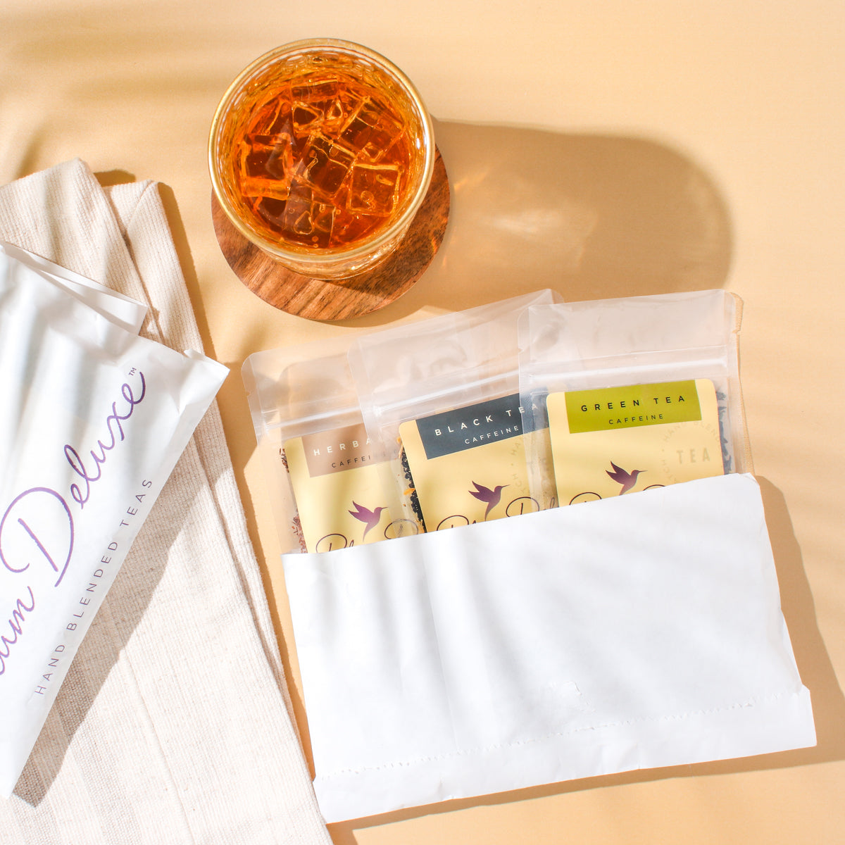 Assorted herbal teas from Plum Deluxe Tea Mystery Tea Trio set, featuring colorful tea bags in a gift box.