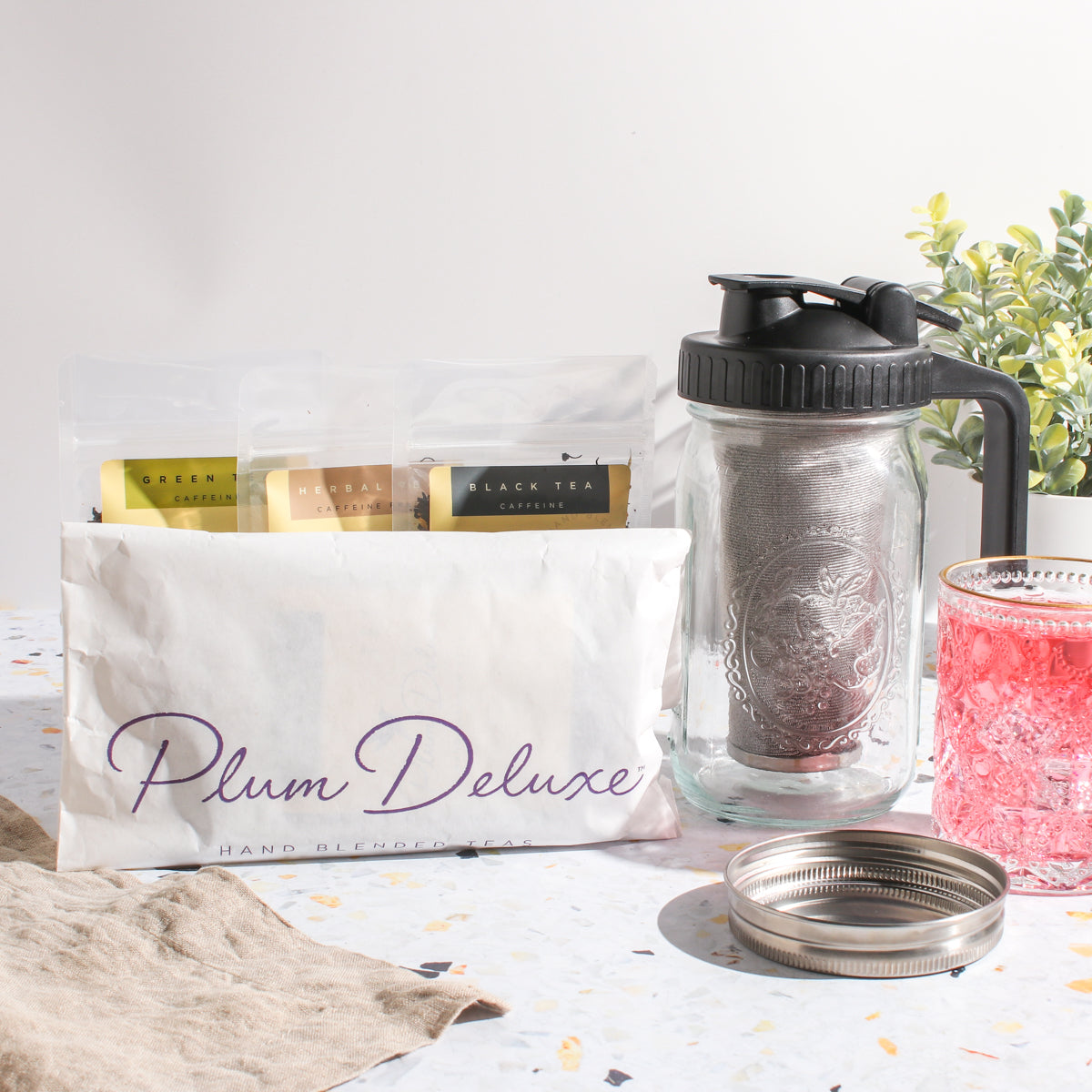 Maison Brew Cold Brew Iced Tea Mason Jar by Plum Deluxe Tea, clear glass jar with a metal lid for brewing and serving iced tea.