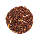 Plum Deluxe Tea Hunnybush Herbal Tea in a clear glass mug with blooming tea flowers and fresh herbs, showcasing vibrant herbal ingredients.