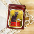 Le Chat Noir tea tin by Plum Deluxe Tea featuring a vintage black cat design on a round metal container.