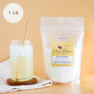 Plum Deluxe Tea Deluxe Lemonade Mix in a colorful package with lemon slices and tea ingredients.