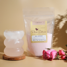 Plum Deluxe Tea Deluxe Lemonade Mix in a clear container, featuring vibrant lemon slices and powdered mix for refreshing lemonade.