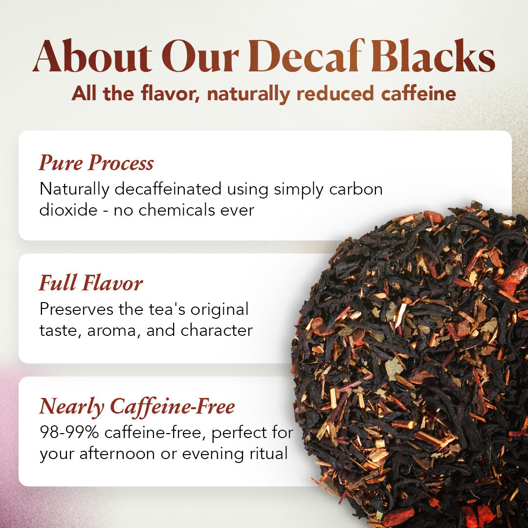 Cup of Plum Deluxe Reading Nook Tea Blend with rose, lavender, and chamomile flowers in a cozy setting.