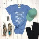 Gray V-neck graphic tee from The Graphic Tee with positive mind, vibes, and life slogan in bold black lettering.