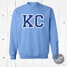 Powder blue KC glitter applique crewneck sweatshirt by The Graphic Tee, featuring a stylish glitter design on soft fabric.