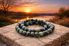 Faceted Ruby Zoisite bracelet with 8mm beads, showcasing vibrant green and red gemstone stones on a stretch cord.