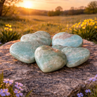 Caribbean Calcite hearts from Practical Magic Store, polished gemstone with vibrant blue and green hues, smooth and heart-shaped.