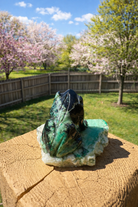 Emerald frog carving from Practical Magic Store, detailed green gemstone sculpture of a frog with intricate carvings
